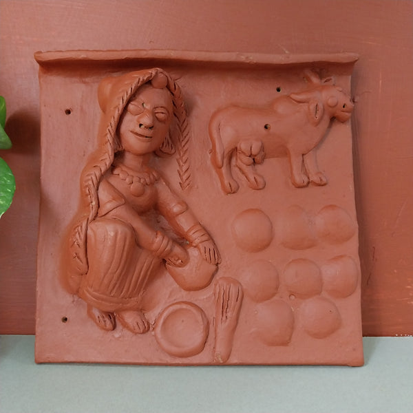 Terracotta woman making dung cakes Tile