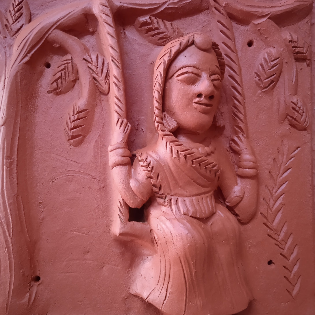 Terracotta woman on swing