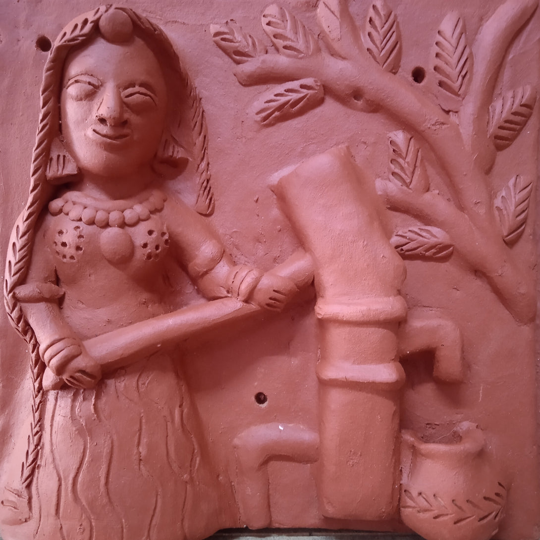 Terracotta woman at hand pump